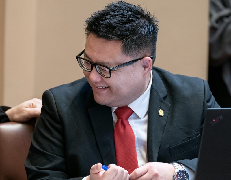 State Senator Tou Xiong discusses senate business during a floor session.