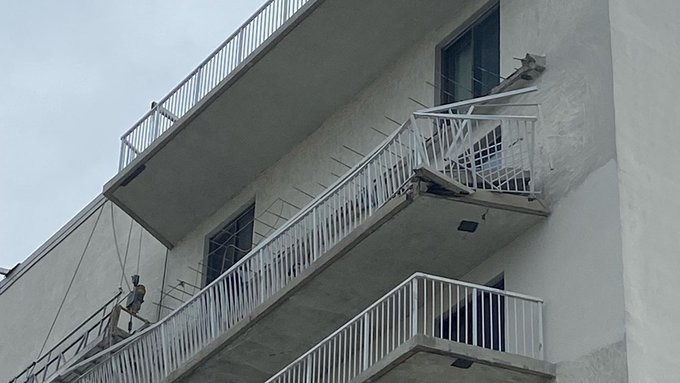 A balcony collapsed at a Seal Isle City condominium building on Friday, trapping a worker beneath.