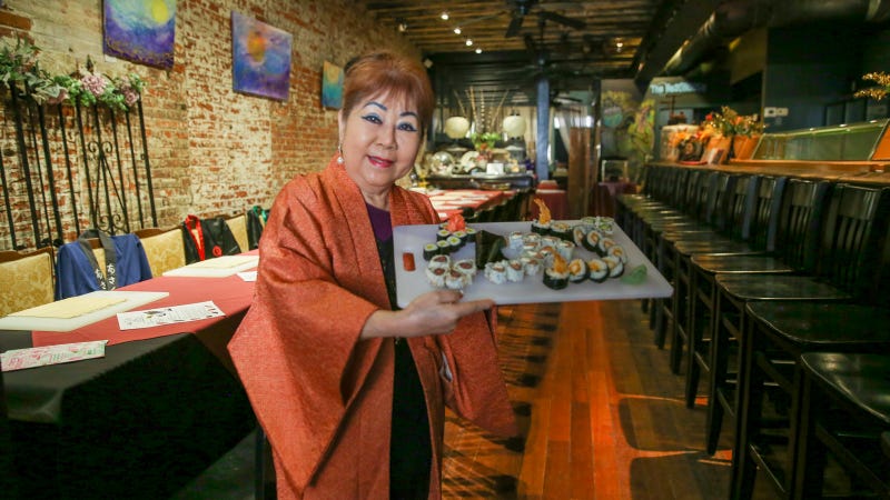 Madame Saito presents an array of sushi rolls, which she teaches others how to make in her classes.