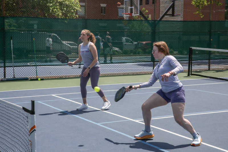 KYW's Sabrina Boyd-Surka (left) and Bibiana Correa give pickleball a try.