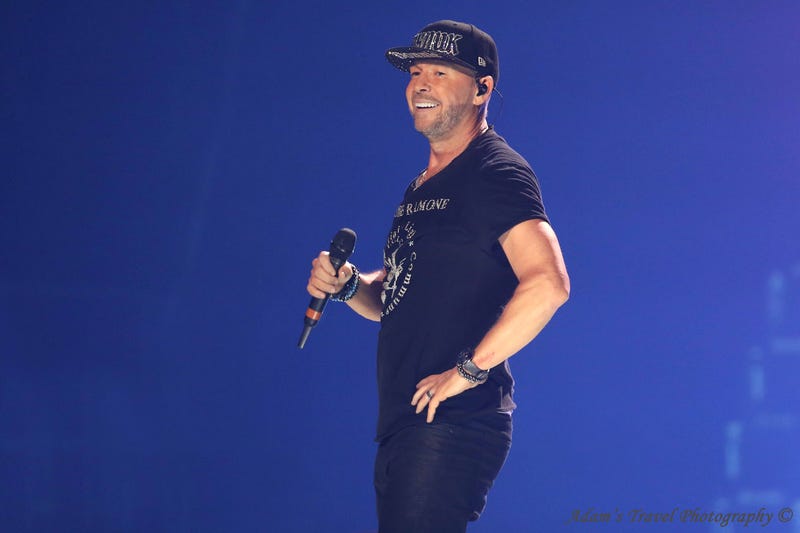 Man on stage holding microphone