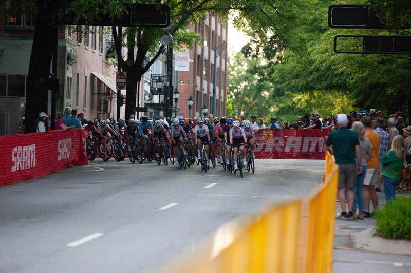 Racers in the Greenville Cycling Classic curve a turn in downtown Greenville