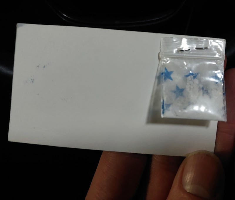 Cocaine stapled to a business card. 
