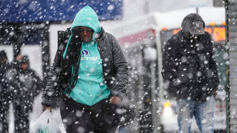 Pedestrians navigate Philadelphia streets during a winter snowstorm Tuesday.