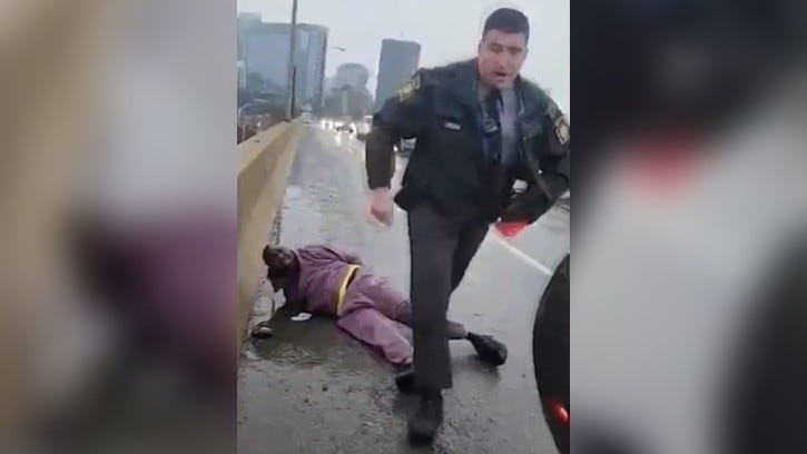 After handcuffing Darius McLean, the state trooper moves on to detain Celena Morrison, who had been recording the incident.