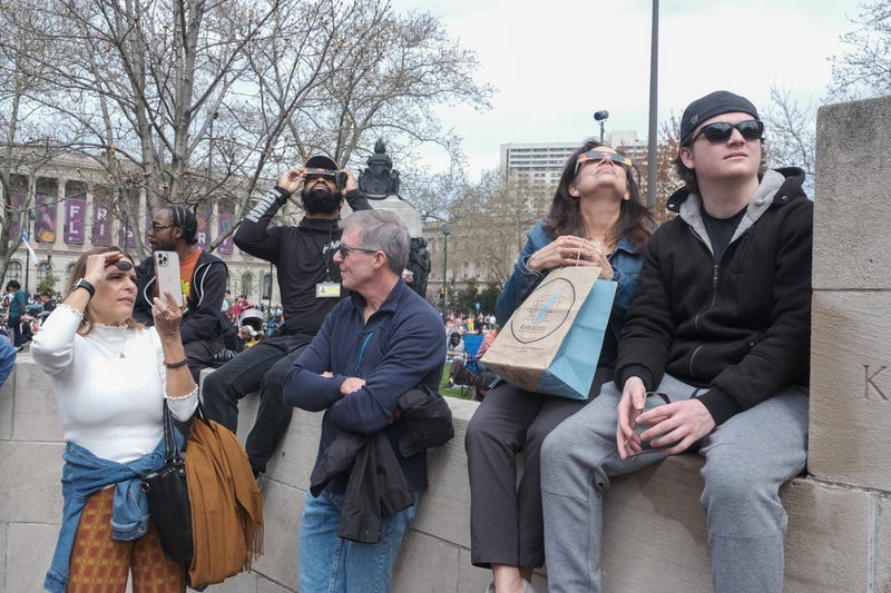 People look up at the Solar Eclipse over Philadelphia on April 8, 2024