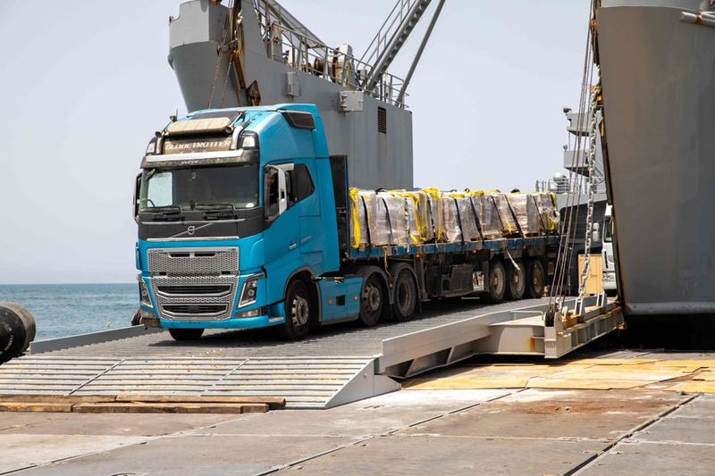 A truck carrying humanitarian aid moves off the causeway in Gaza.