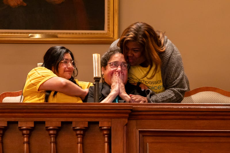 Supporters of a bill to legalize “medical aid in dying” cry as it passes in the Illinois House on Thursday. Pictured left to right: Daisy Orihuela, Amy Sherman and Donna Smith.