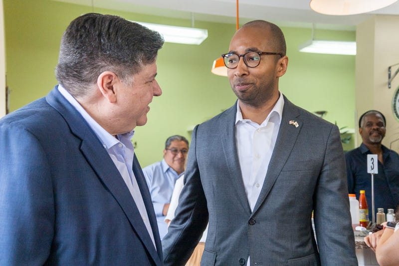 Christian Mitchell speaks to Gov. JB Pritzker while meeting with supporters at Peach’s Restaurant in Chicago’s Bronzeville neighborhood on July 2.