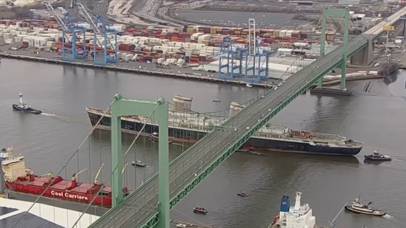 The SS United States passes below the Walt Whitman Bridge on its way out of Philadelphia.