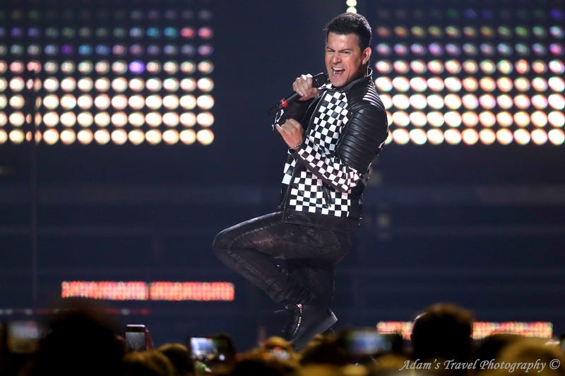 Man on stage in black and white checkered jacket
