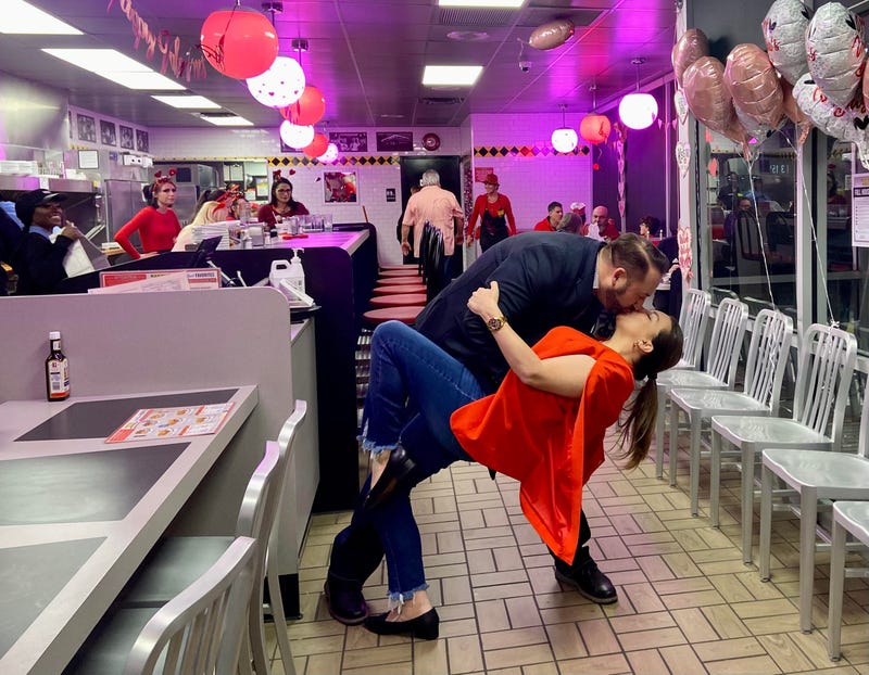 Couple shares a romantic kiss in their local Waffle House.