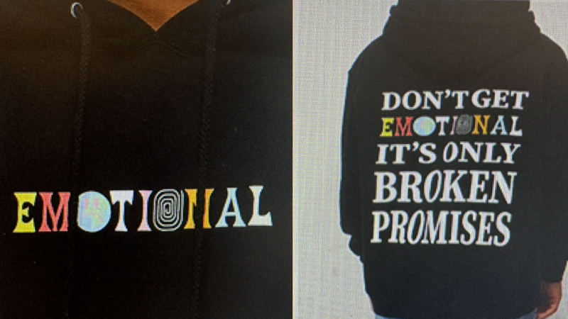 One of the suspects was last seen wearing a black hoodie with the words “DON’T GET EMOTIONAL IT’S ONLY BROKEN PROMISES” printed on the back, and "EMOTIONAL" printed on the front.