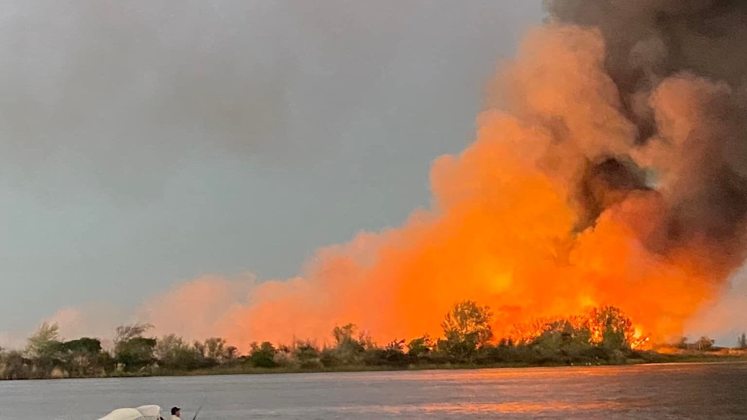 PHOTOS: Vegetation fire ignites on island near East Bay, could burn for days