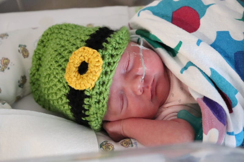 Newborn with leprechaun hat on St. Patrick's Day 2022