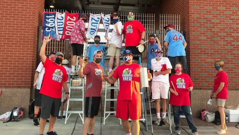 The Phanatic Krew in 2020, watching Phillies games by using ladders to see the contest from the outside of Citizens Bank Park.