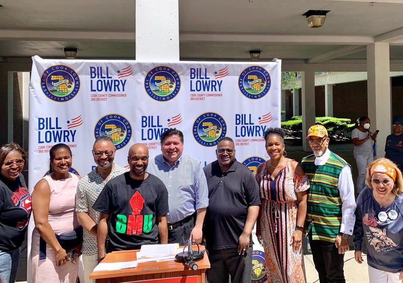 Gov. J.B. Pritzker, Commissioners Deer and Lowry, stand at a Juneteenth event.