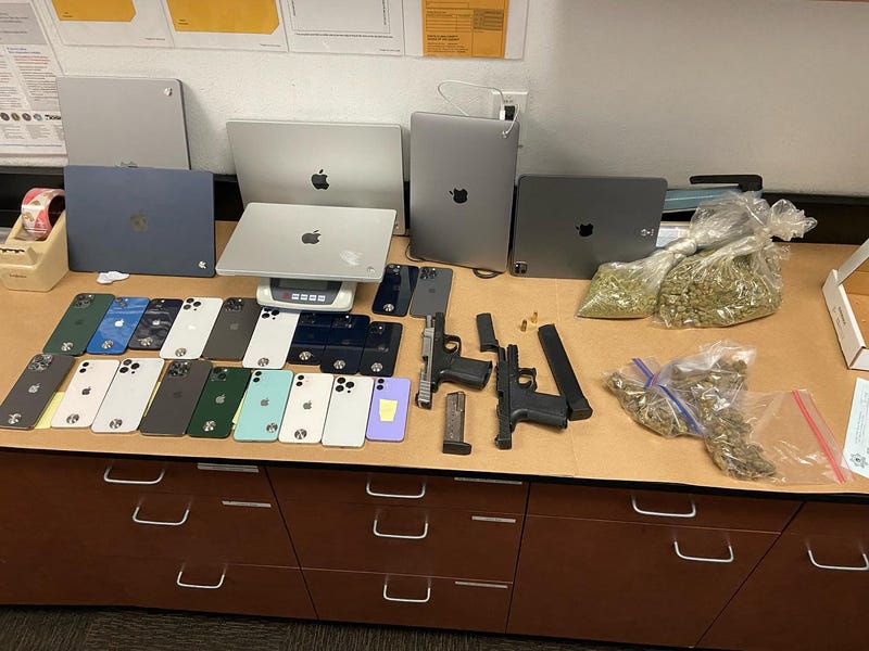 The recovered merchandise and guns seized during the search.