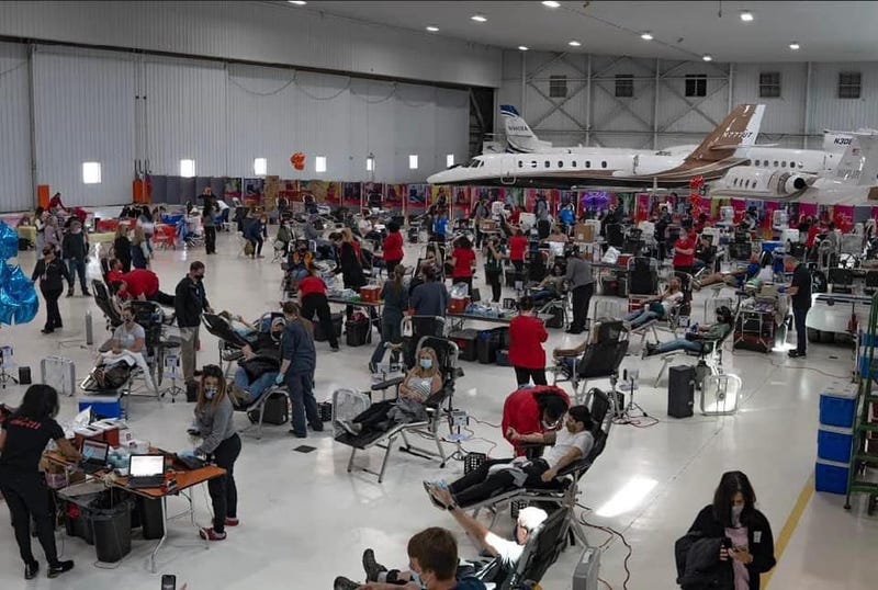 Hangar full of people donating blood