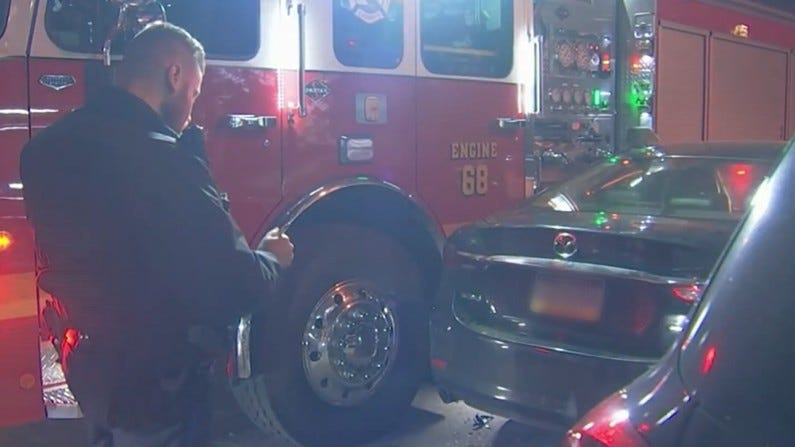 After running over a firefighter's foot, a suspected drunk driver got his car wedged between a fire engine and a parked car.