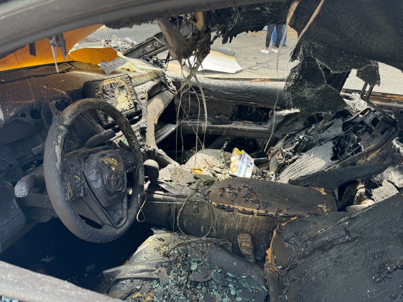 The charred inside of a Toyota sedan is seen on East 174th Street