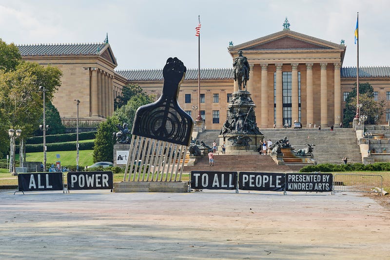 Titled "All Power to All People," this sculpture by artist Hank Willis Thomas stands in front of the Philadelphia Museum of Art, part of Kindred Arts' "Monumental Tour."