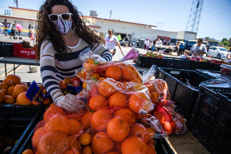 A woman sets up a food donation site for 3 Square Food Bank