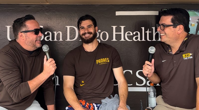 Ben and Woods talk with Padres starting pitcher Dylan Cease down in the dugout prior before Wednesday's game at Petco Park against the Colorado Rockies