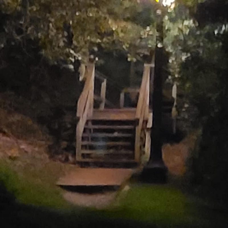 Ghostly figure sitting on a staircase