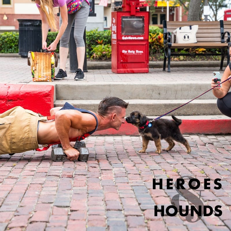 A Galveston firefighter poses with a puppy.