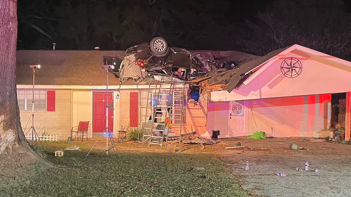 Woman crashes car into roof of Louisiana home