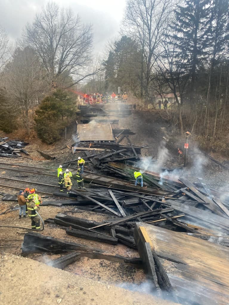 Authorities are investigating the cause of a raging fire that engulfed a wooden historic bridge in Mid Michigan and ultimately led to its collapse over the weekend