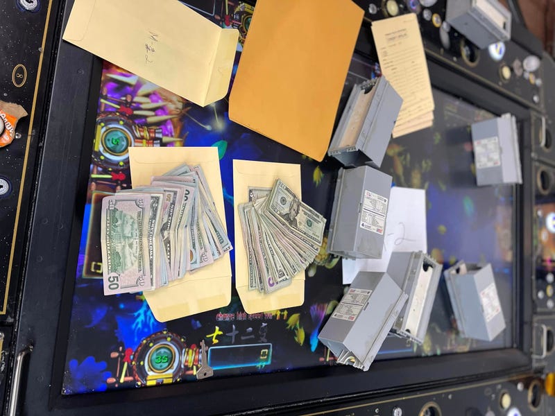 piles of cash and electronic devices