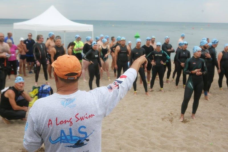 Doug McConnell directs a group of swimmers about to participate in one of A Long Swim's open water fundraiser swims.