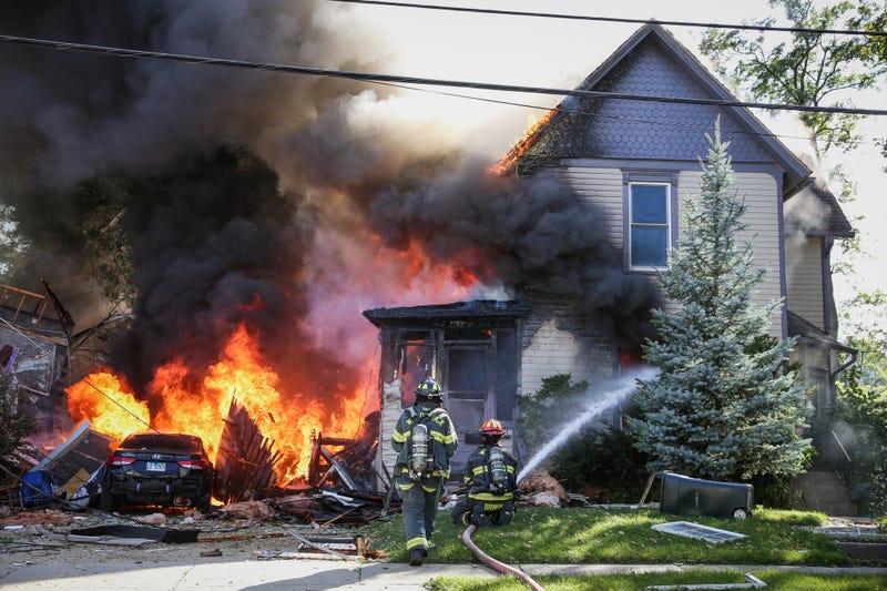 Woodstock firefighters battle a fire after a house exploded Monday afternoon.