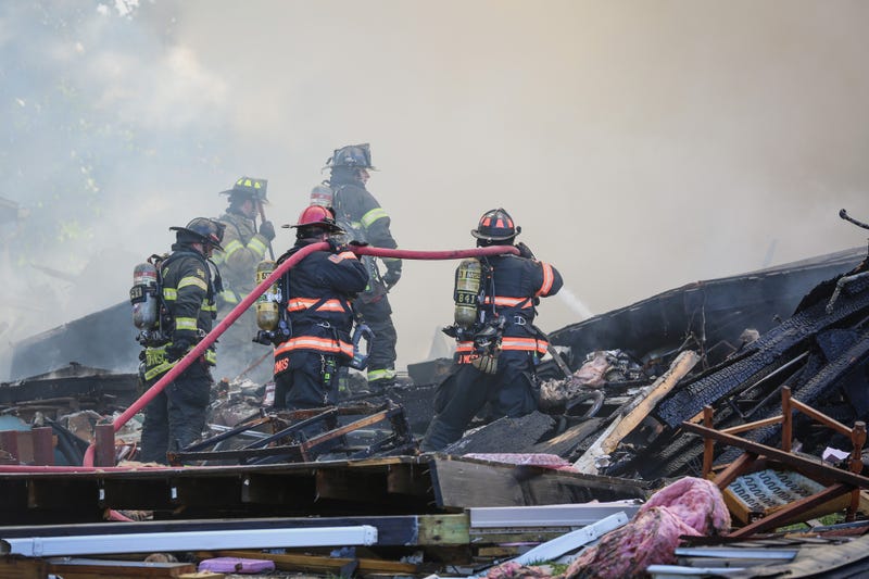 Woodstock firefighters douse a fire after a house explosion on Monday.