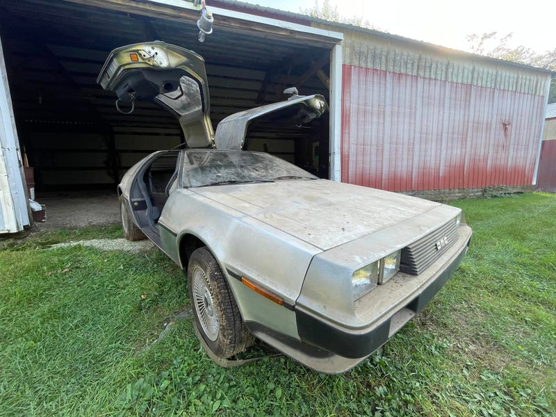 DeLorean in front of a barn