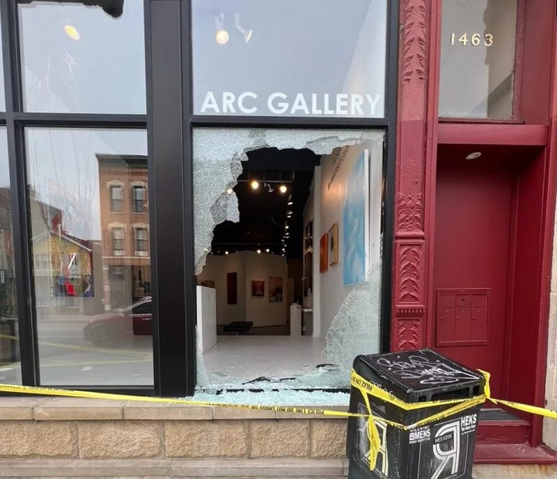 Broken window at ARC Gallery in Chicago's West Town neighborhood. The gallery is cordoned off with police tape.