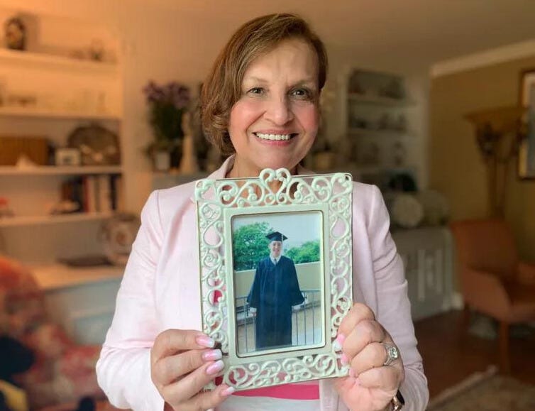 Judi Reiss holds a photograph of her son Joshua on the 20th anniversary of his death.