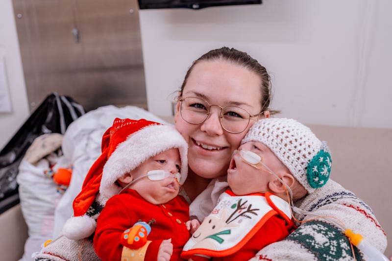 Woman holding two babies