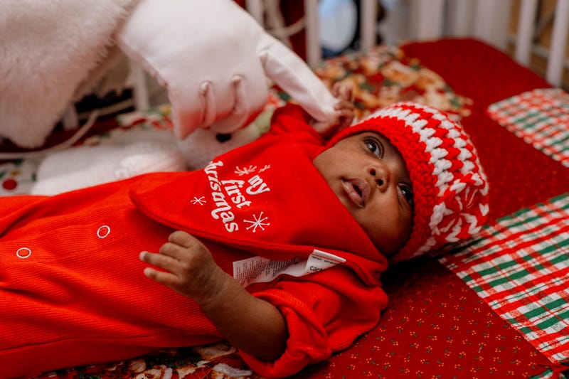Tiny baby in red onesie