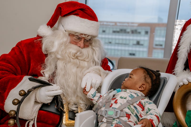 Baby with Santa and Mrs. Claus