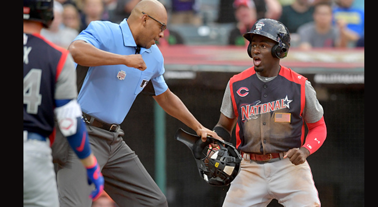 JULY 07: Home plate umpire Jose Navas punches out Taylor Trammell #7 of the National League after he tried to steal home during the fourth inning against the American League team during the All-Stars Futures Game at Progressive Field on July 07, 2019 in C