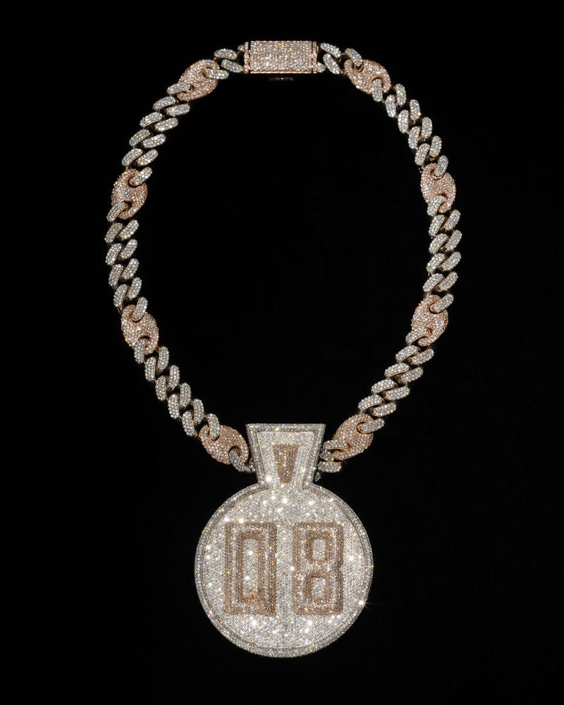 Featuring white and rose gold, this custom diamond-encrusted Queensbridge pendant was commissioned from Pristine Jewelers by Nas in 2018 to commemorate Queensbridge Houses in Queens, New York, where he grew up.