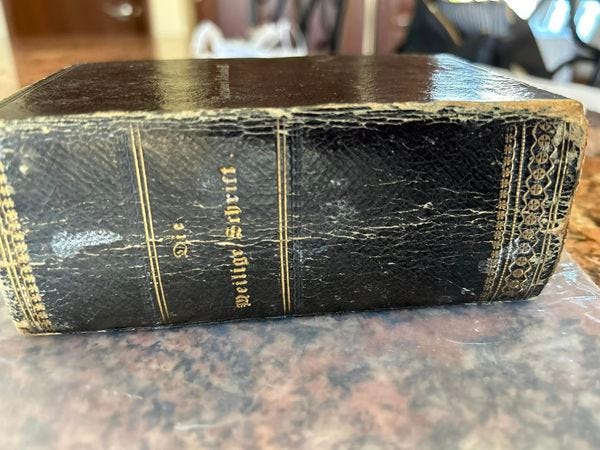 An old, German Bible rests on a table. Chicagoan Helga Simms said the book was discovered in her childhood home many years ago — and now she and her daughter are on a quest to return the book to its proper owners.