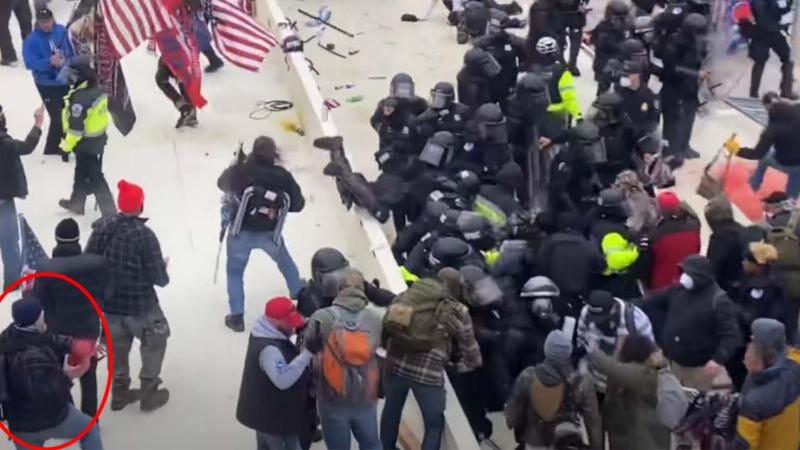 Robert Sanford is seen on video throwing a fire extinguisher into a group of police officers during the riots at the Capitol on Jan. 6, 2021.