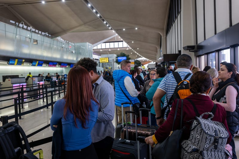 People wait in line for a delayed flight at Newark airport on May 5.