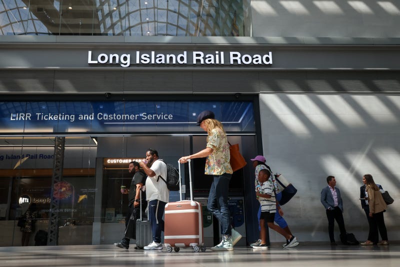 Commuters near Long Island Rail Road signage at Moynihan Train Hall in New York on Sept. 15, 2025