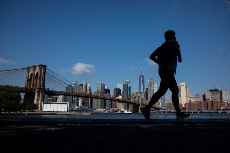 A jogger runs along the water in the Dumbo neighborhood in the Brooklyn borough of New York.