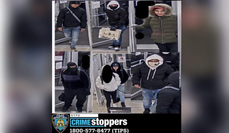 Police are searching for a half-dozen suspects in a pair of grand larcenies at a Sunglass Hut at the Macy's in downtown Flushing